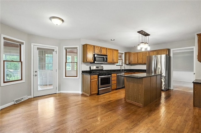 109 Hamilton Ct, Economy, PA 15005 - kitchen featuring appliances with stainless steel finishes, dark countertops, and brown cabinetry