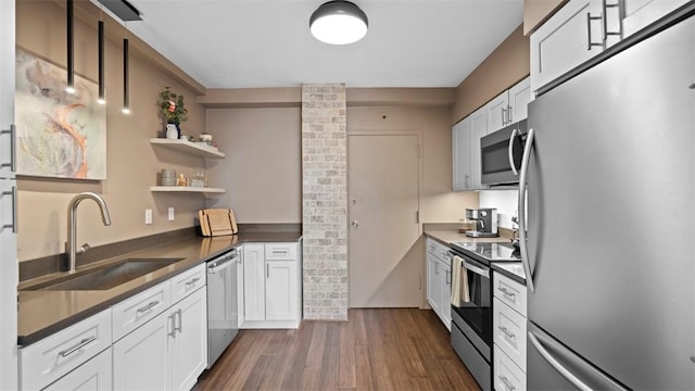128 N Craig St Unit 505, Oakland, PA 15213 - kitchen featuring appliances with stainless steel finishes, dark countertops, dark wood finished floors, and open shelves