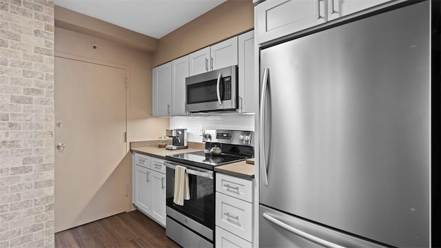 128 N Craig St Unit 505, Oakland, PA 15213 - kitchen with stainless steel appliances, dark wood-style floors, tasteful backsplash, white cabinetry, and light countertops