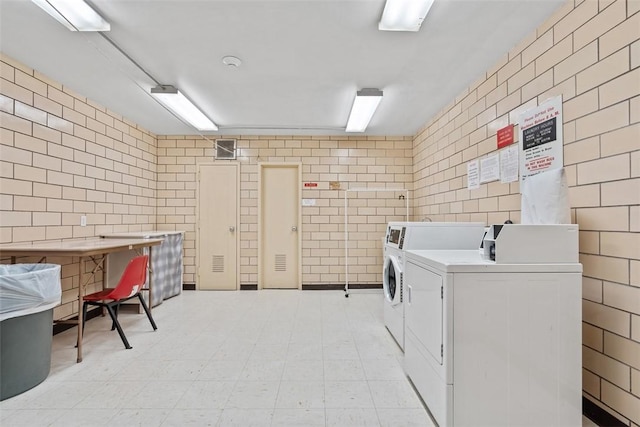 128 N Craig St Unit 505, Oakland, PA 15213 - community laundry with tile walls, washer and dryer, and light flooring