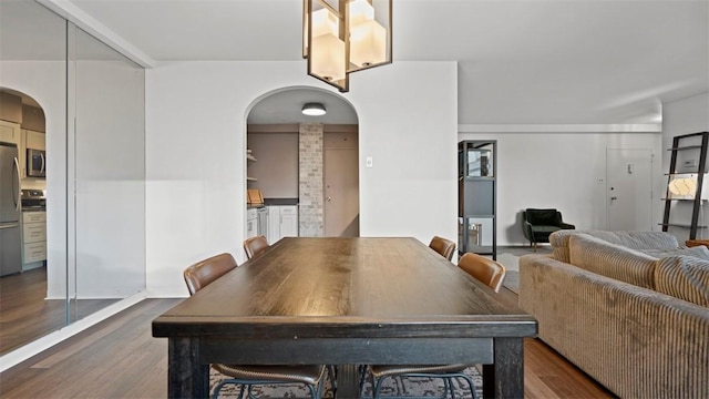 128 N Craig St Unit 505, Oakland, PA 15213 - dining room featuring arched walkways and dark wood-type flooring
