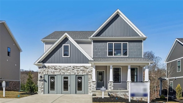 412 Barons Ct, Peters Twp, PA 15367 - craftsman-style house with covered porch, stone siding, and board and batten siding