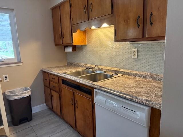 465 Chadwick St, Sewickley, PA 15143 - kitchen with white dishwasher, decorative backsplash, light tile patterned floors, and brown cabinets