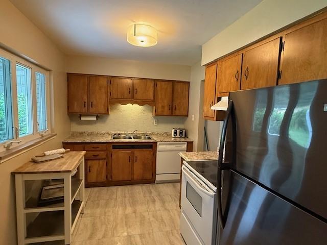 465 Chadwick St, Sewickley, PA 15143 - kitchen featuring white appliances, brown cabinetry, light countertops, and ventilation hood