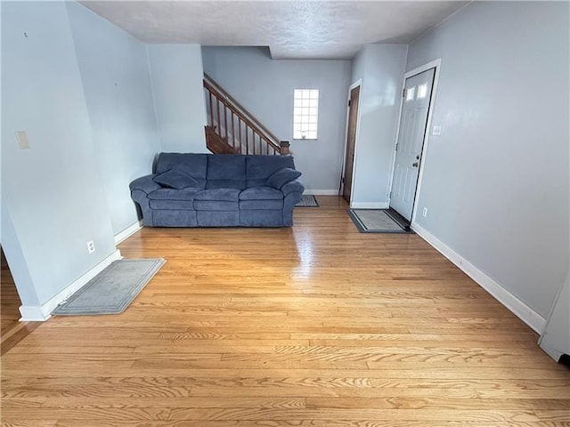1606 Maryland Ave, West Mifflin, PA 15122 - living room featuring light wood-type flooring and stairway