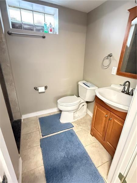1606 Maryland Ave, West Mifflin, PA 15122 - full bath featuring vanity, tile patterned flooring, and a shower