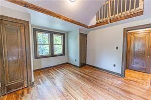 9502 Frankstown, Penn Hills, PA 15235 - unfurnished bedroom with lofted ceiling and wood finished floors