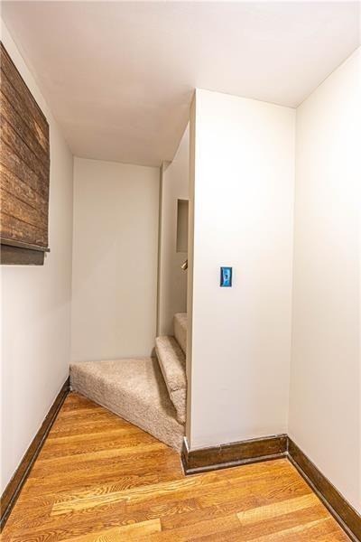 9502 Frankstown, Penn Hills, PA 15235 - corridor featuring wood finished floors and stairs