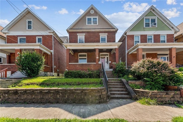 312 Edgewood Ave, Trafford, PA 15085 - american foursquare style home with covered porch, brick siding, and stairway