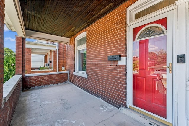 312 Edgewood Ave, Trafford, PA 15085 - property entrance with a porch and brick siding