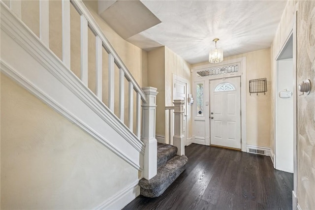 312 Edgewood Ave, Trafford, PA 15085 - foyer entrance with dark wood finished floors, stairs, and a chandelier