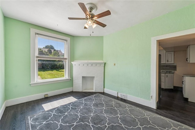 312 Edgewood Ave, Trafford, PA 15085 - unfurnished living room featuring dark wood-style floors, a ceiling fan, and a brick fireplace