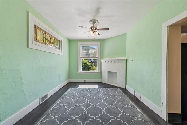 312 Edgewood Ave, Trafford, PA 15085 - unfurnished living room featuring ceiling fan, wood finished floors, and a brick fireplace
