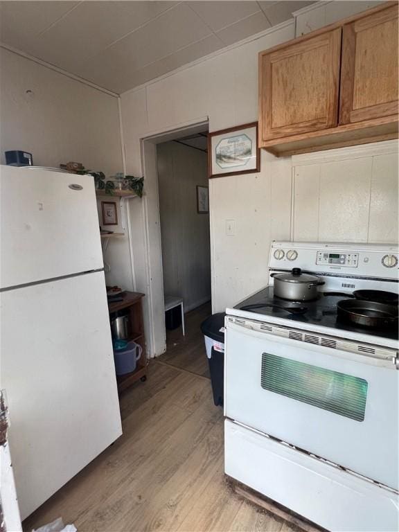 306 Fallowfield Ave, Charleroi Boro, PA 15022 - kitchen featuring white appliances, light wood-type flooring, and brown cabinets