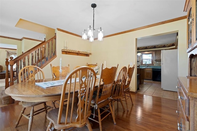 4581 Bakerstown Culmerville Rd, West Deer, PA 15044 - dining space with crown molding, light wood-type flooring, a chandelier, and stairway