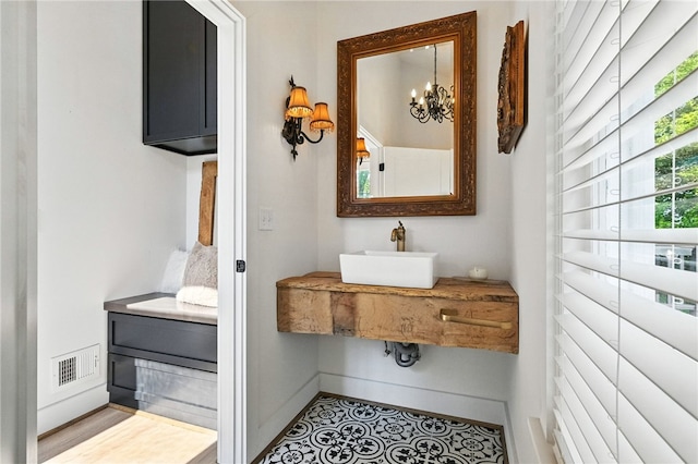3901 Bakerstown Rd, Richland, PA 15044 - bathroom with a sink and a chandelier