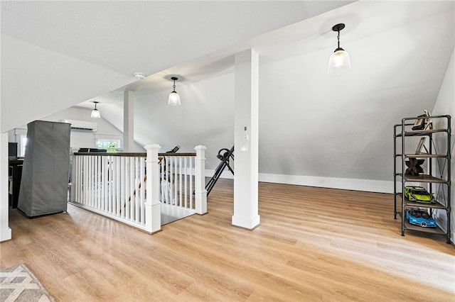 3901 Bakerstown Rd, Richland, PA 15044 - additional living space with a wall mounted air conditioner, wood finished floors, and vaulted ceiling
