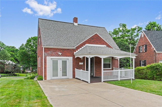 21 Garden Ter, Churchill Boro, PA 15221 - view of front of house featuring covered porch, brick siding, roof with shingles, and french doors