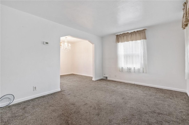 21 Garden Ter, Churchill Boro, PA 15221 - empty room with arched walkways, carpet floors, and a chandelier