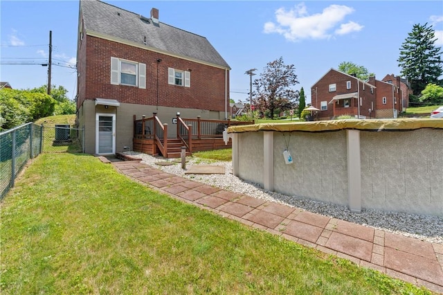 21 Garden Ter, Churchill Boro, PA 15221 - back of property with a wooden deck, a shingled roof, brick siding, and a chimney