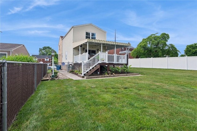 1417 Riverview Dr, Verona, PA 15147 - back of property with a fenced backyard, a wooden deck, and stairs