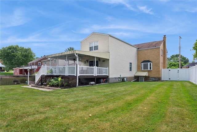 1417 Riverview Dr, Verona, PA 15147 - back of property with a fenced backyard, a deck, and a gate