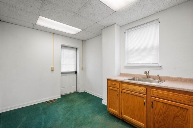 408 Lydia St, Carnegie, PA 15106 - kitchen featuring a paneled ceiling, light countertops, dark colored carpet, and brown cabinetry