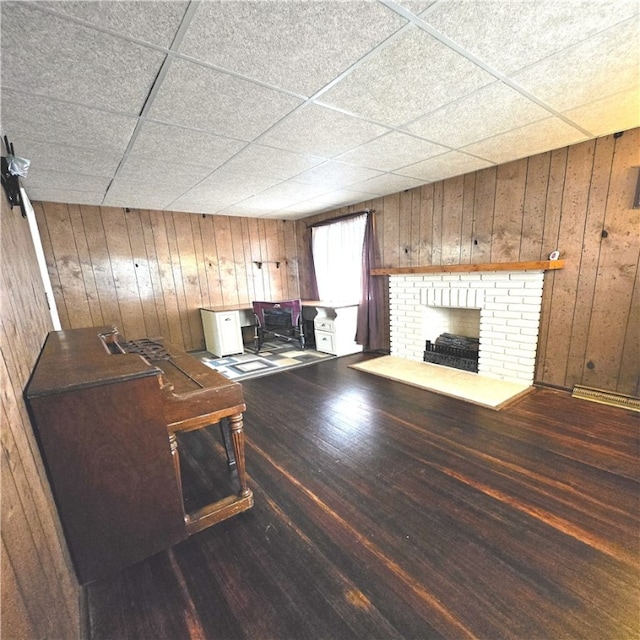 76 Foch Cir, Nemacolin, PA 15351 - living room with wooden walls, a drop ceiling, a fireplace, and wood finished floors