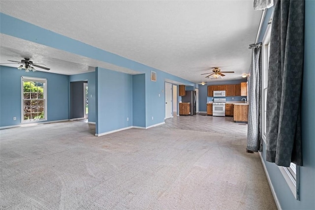 1445 Bristol Dr, South Park, PA 15129 - unfurnished living room with a ceiling fan, light colored carpet, and a textured ceiling