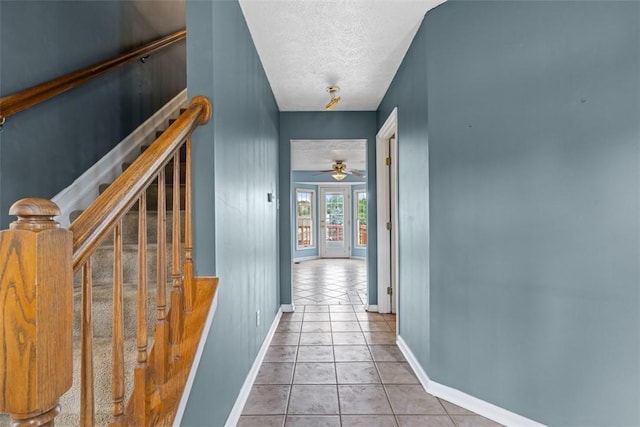 1445 Bristol Dr, South Park, PA 15129 - hallway with tile patterned floors, a textured ceiling, and stairway