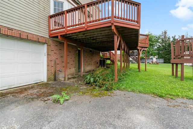 1445 Bristol Dr, South Park, PA 15129 - view of property exterior featuring a deck, an attached garage, brick siding, and a yard