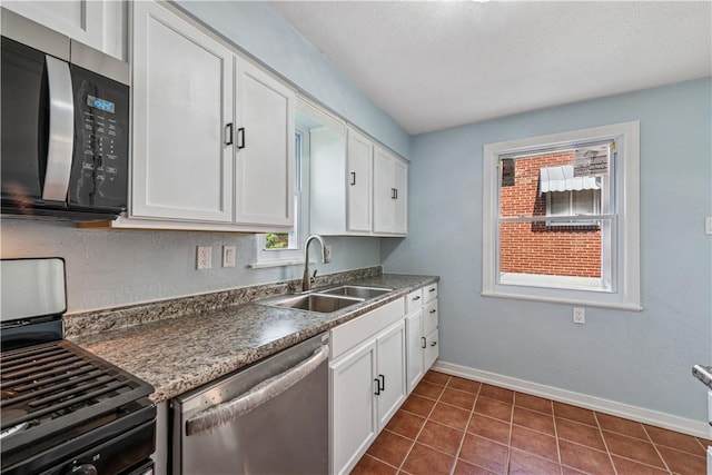 451 Charlotte Dr, Baldwin Boro, PA 15236 - kitchen featuring stainless steel appliances, white cabinetry, and dark tile patterned floors