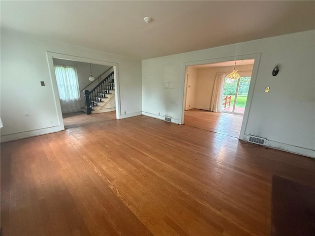 103 Belmont Rd, Twp Of But Ne, PA 16001 - unfurnished room featuring stairs, wood finished floors, and a chandelier