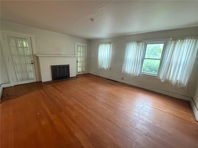 103 Belmont Rd, Twp Of But Ne, PA 16001 - unfurnished living room featuring wood finished floors and a fireplace with flush hearth
