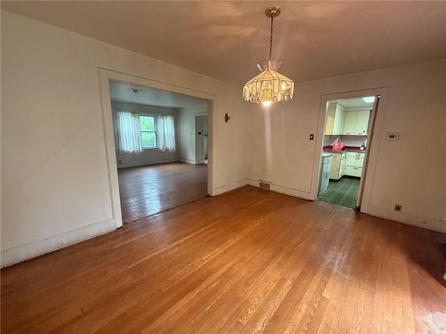 103 Belmont Rd, Twp Of But Ne, PA 16001 - unfurnished dining area with light wood-style flooring and a chandelier