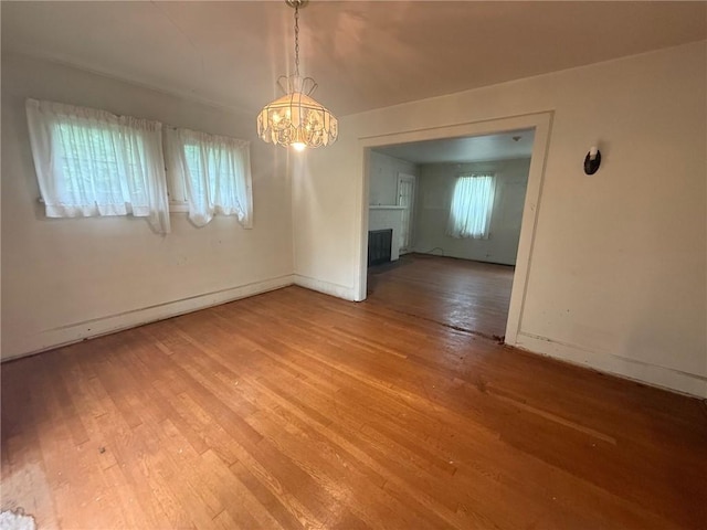103 Belmont Rd, Twp Of But Ne, PA 16001 - spare room featuring light wood finished floors, a chandelier, and a fireplace