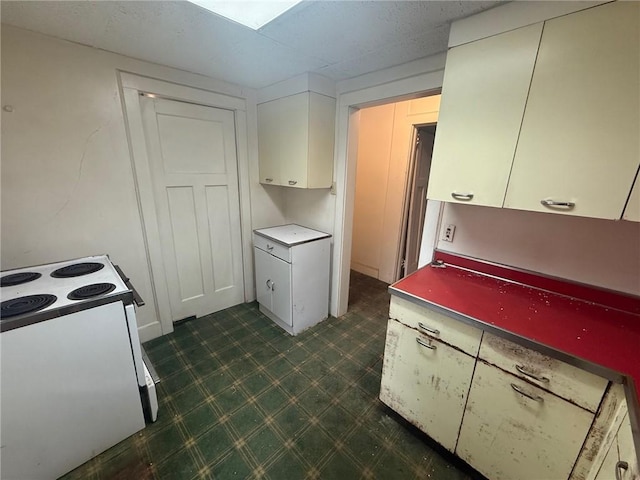 103 Belmont Rd, Twp Of But Ne, PA 16001 - kitchen with white electric range oven, dark flooring, and white cabinets