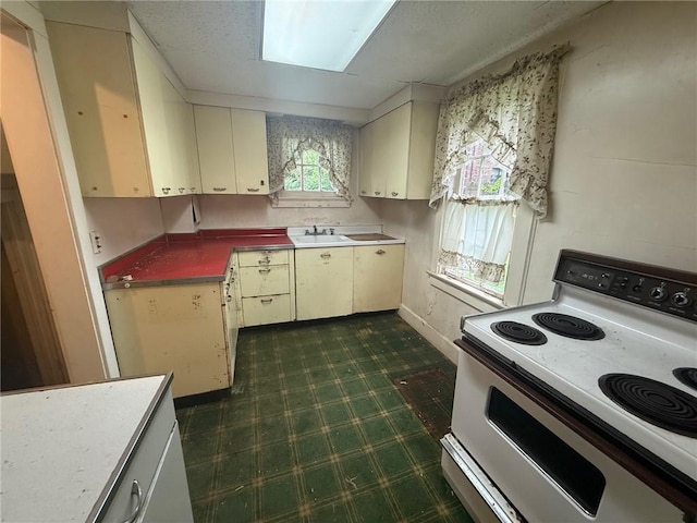 103 Belmont Rd, Twp Of But Ne, PA 16001 - kitchen with electric range and dark flooring
