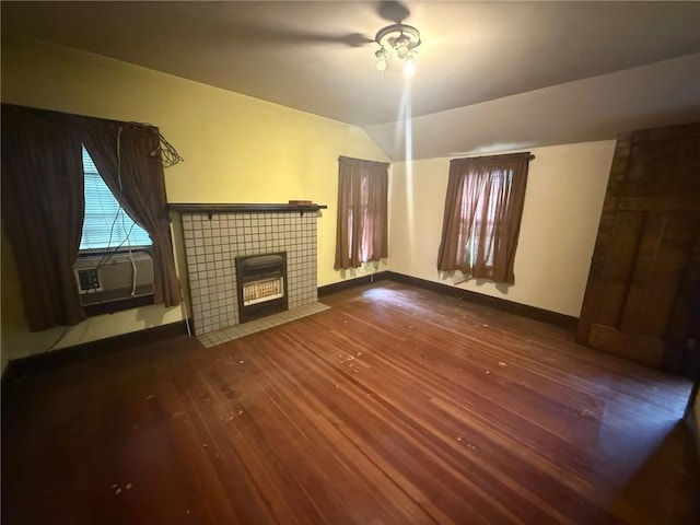 103 Belmont Rd, Twp Of But Ne, PA 16001 - unfurnished living room with dark wood-type flooring, a tiled fireplace, and lofted ceiling