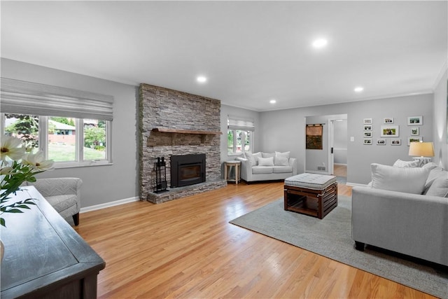 2633 Cedarvue Dr, Saint Clair, PA 15241 - living room featuring wood finished floors, recessed lighting, a stone fireplace, and crown molding