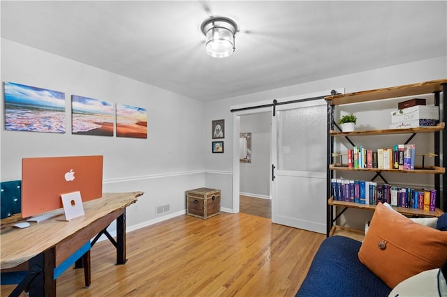 2633 Cedarvue Dr, Saint Clair, PA 15241 - home office with wood finished floors and a barn door
