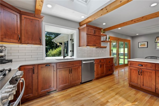 2633 Cedarvue Dr, Saint Clair, PA 15241 - kitchen featuring stainless steel appliances, beam ceiling, light wood-style flooring, light countertops, and backsplash