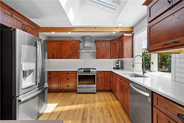 2633 Cedarvue Dr, Saint Clair, PA 15241 - kitchen featuring stainless steel appliances, wall chimney exhaust hood, a skylight, light wood-style flooring, and light countertops