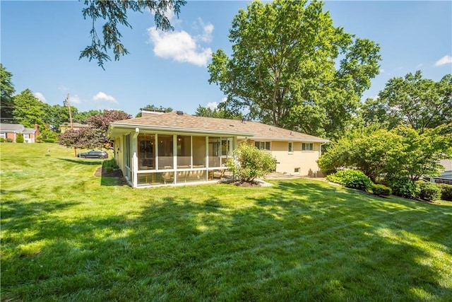 2633 Cedarvue Dr, Saint Clair, PA 15241 - back of house featuring a sunroom, a lawn, and a chimney