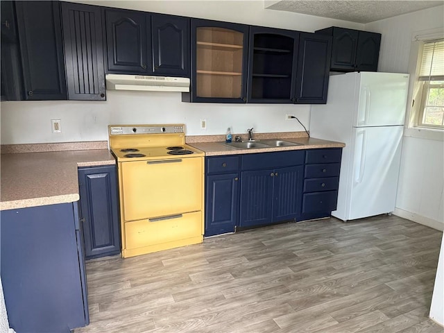 240 2nd Ave, Sharon, PA 16146 - kitchen with white appliances, under cabinet range hood, blue cabinets, light wood-type flooring, and light countertops