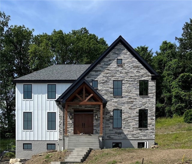 7 Holland Dr, Ohara, PA 15238 - view of front of home with board and batten siding and stone siding