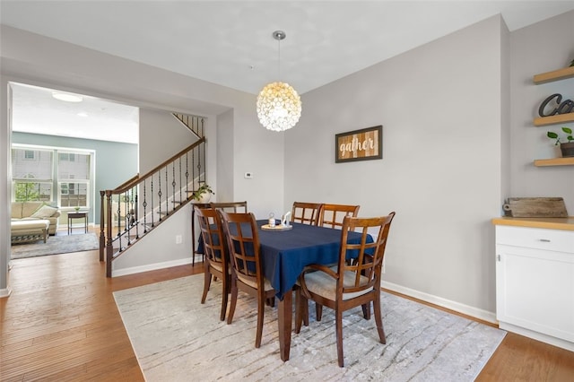 1004 Pointe View Dr, Adams Twp, PA 16046 - dining space with stairway, wood finished floors, and a chandelier