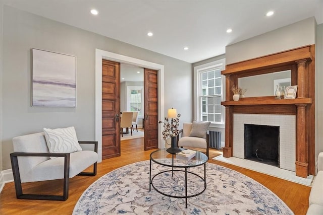 248 Berringer Pl, Ben Avon, PA 15202 - living area featuring radiator, wood finished floors, recessed lighting, and a fireplace with flush hearth