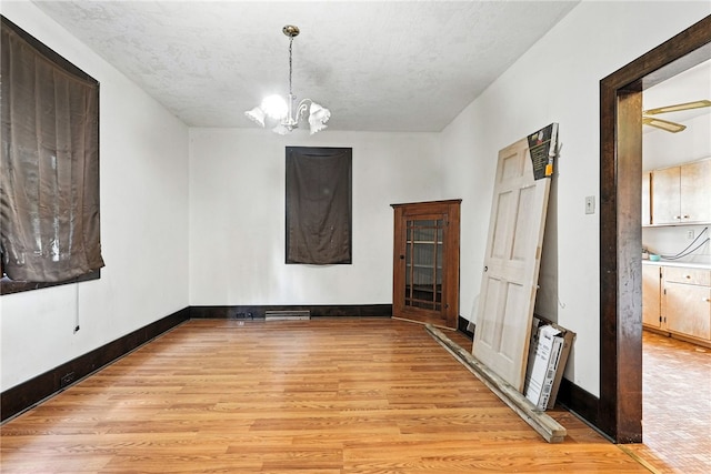 419 8th Ave, Patterson Heights, PA 15010 - empty room featuring light wood-style floors and a chandelier