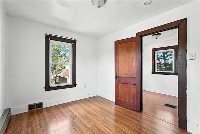 419 8th Ave, Patterson Heights, PA 15010 - empty room with light wood-type flooring and baseboard heating
